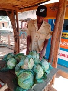 Philip Banda selling cabbages at a local market.